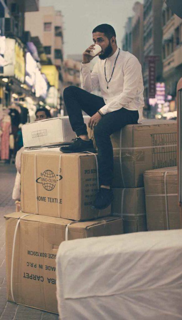 Picture of man sitting on a pile of boxes